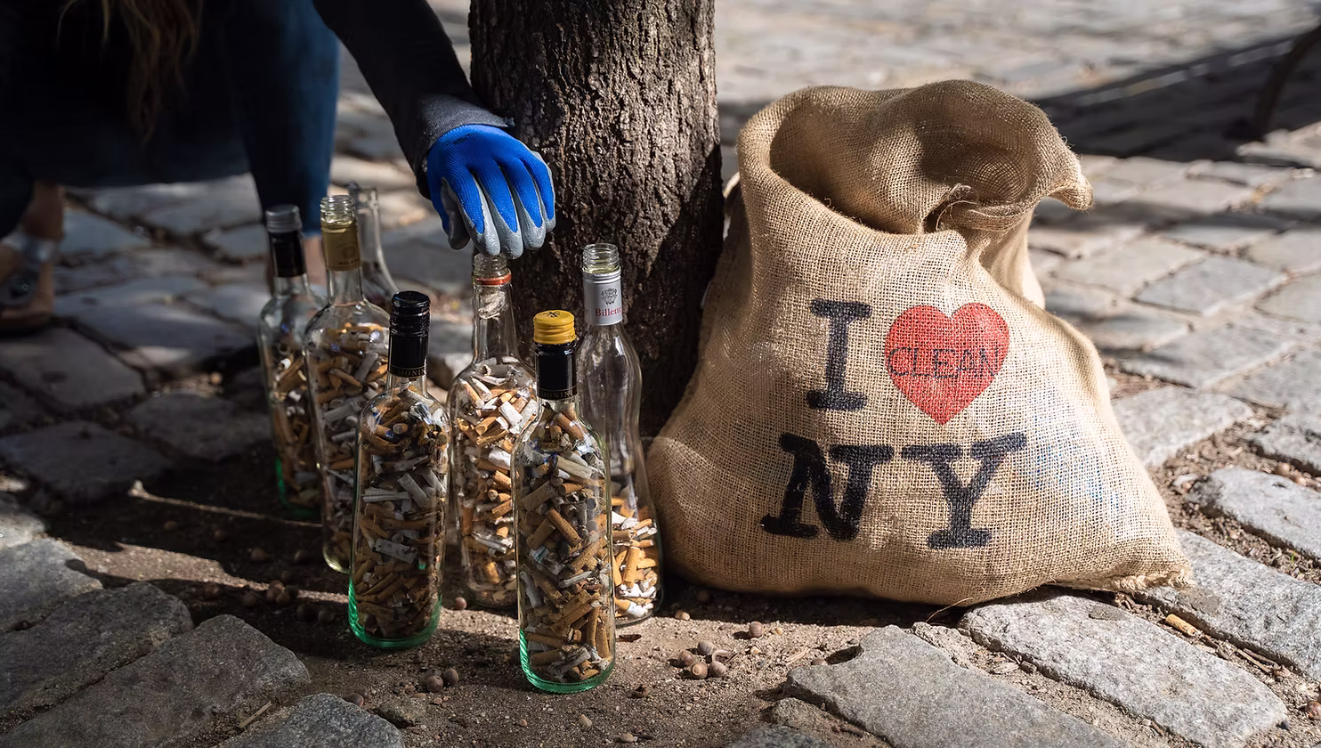 Sack with "I Love NY" beside bottles