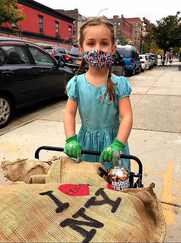 Girl with mask and gloves on sidewalk